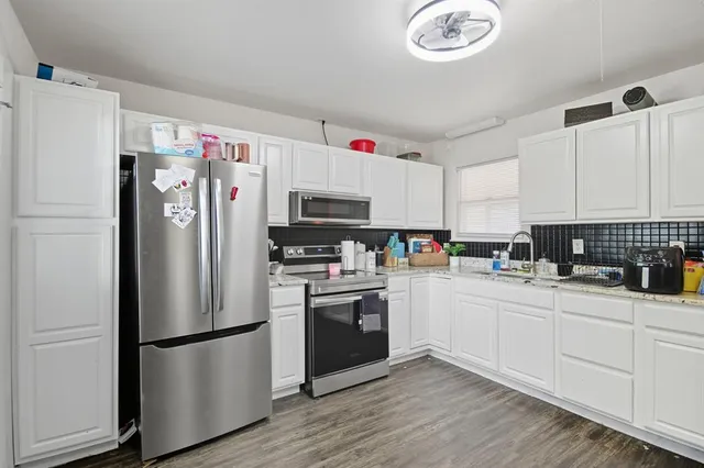 a white refrigerator freezer sitting in a kitchen