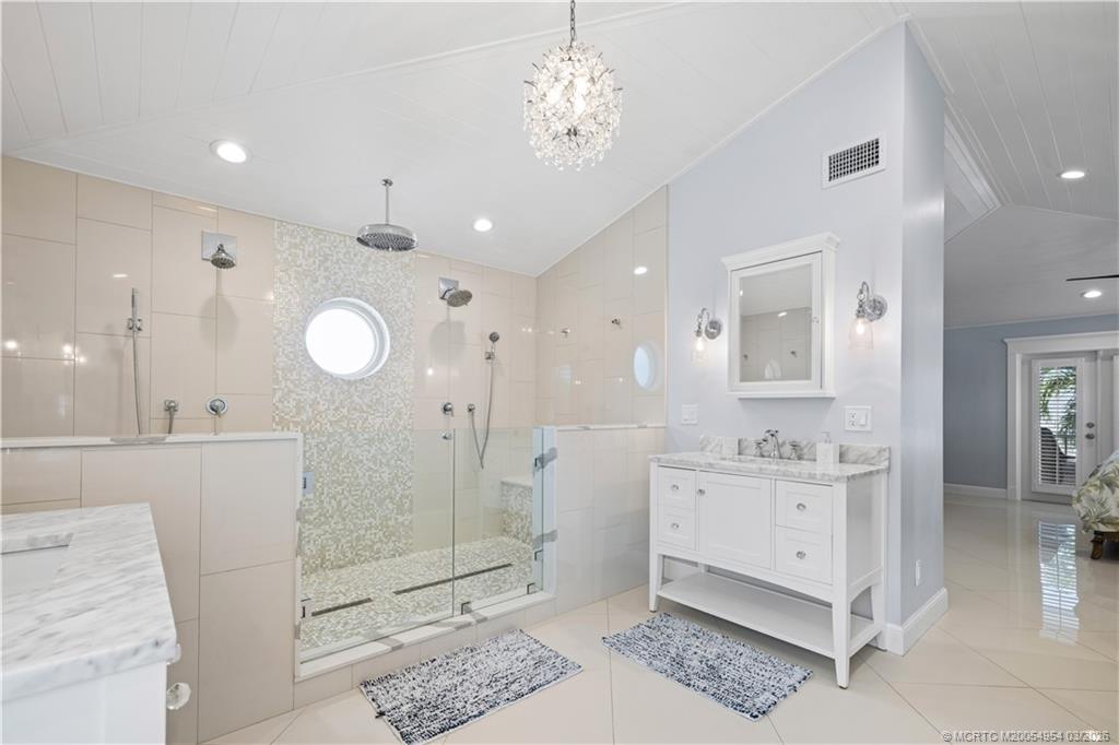 1359 Southwest Dyer Point Road Palm City, FL 34990 - Photo 22 of 55 a spacious bathroom with a double vanity sink a mirror and a shower