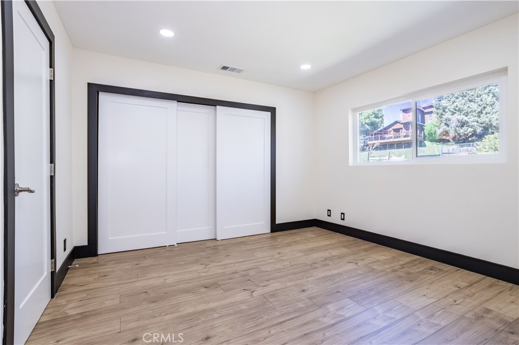 42640 Ranch Club Road Lake Hughes, CA 93532 - Photo 11 of 27 an empty room with wooden floor and window