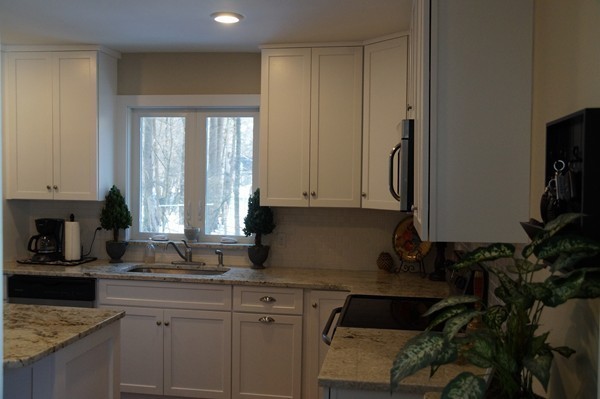 13 Marshbrook Road Billerica, MA 01821 - Photo 6 of 24 a kitchen with granite countertop a sink a stove and cabinets