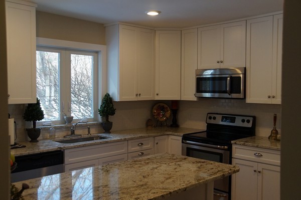 13 Marshbrook Road Billerica, MA 01821 - Photo 7 of 24 a kitchen with stainless steel appliances granite countertop a stove a sink and a microwave