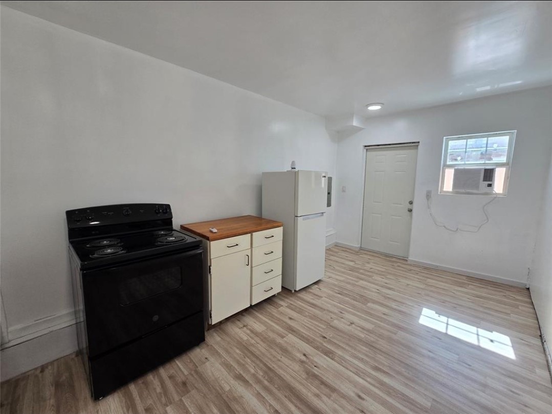 3125 Illinois Street, Unit C Baytown, TX 77520 - Photo 1 of 7 a kitchen with a refrigerator and a stove top oven