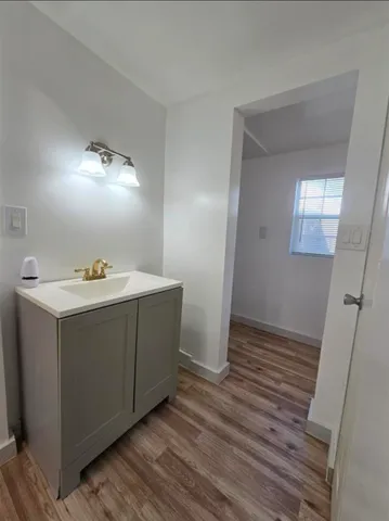 a bathroom with a sink vanity and a mirror