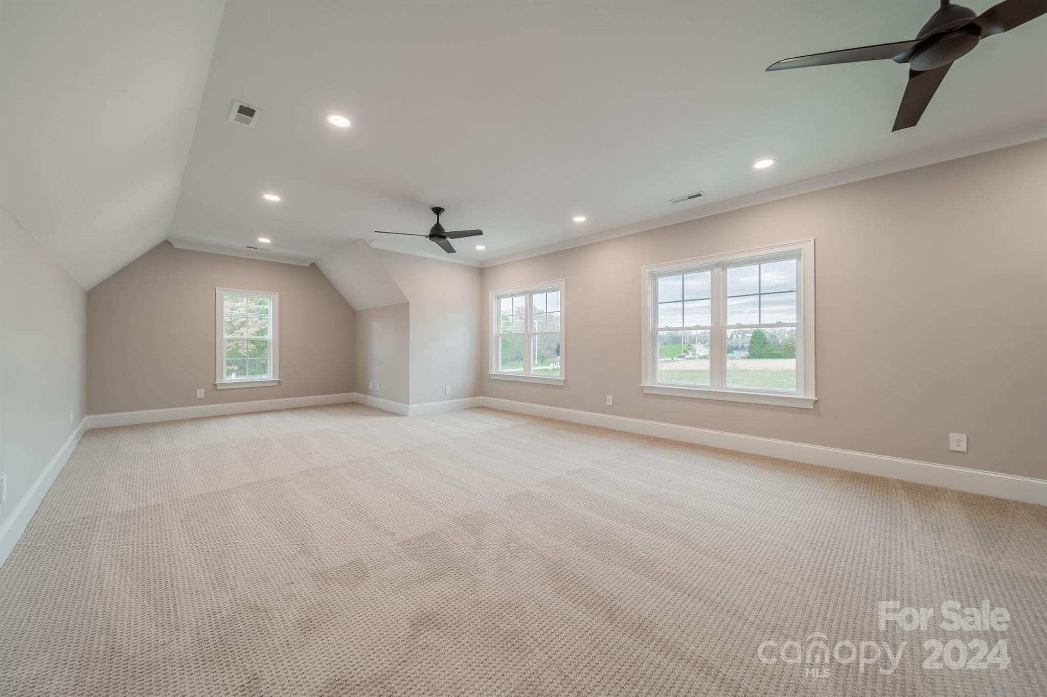 10829 Caroline Acres Road Fort Mill, SC 29707 - Photo 17 of 21 an empty room with windows and ceiling fan