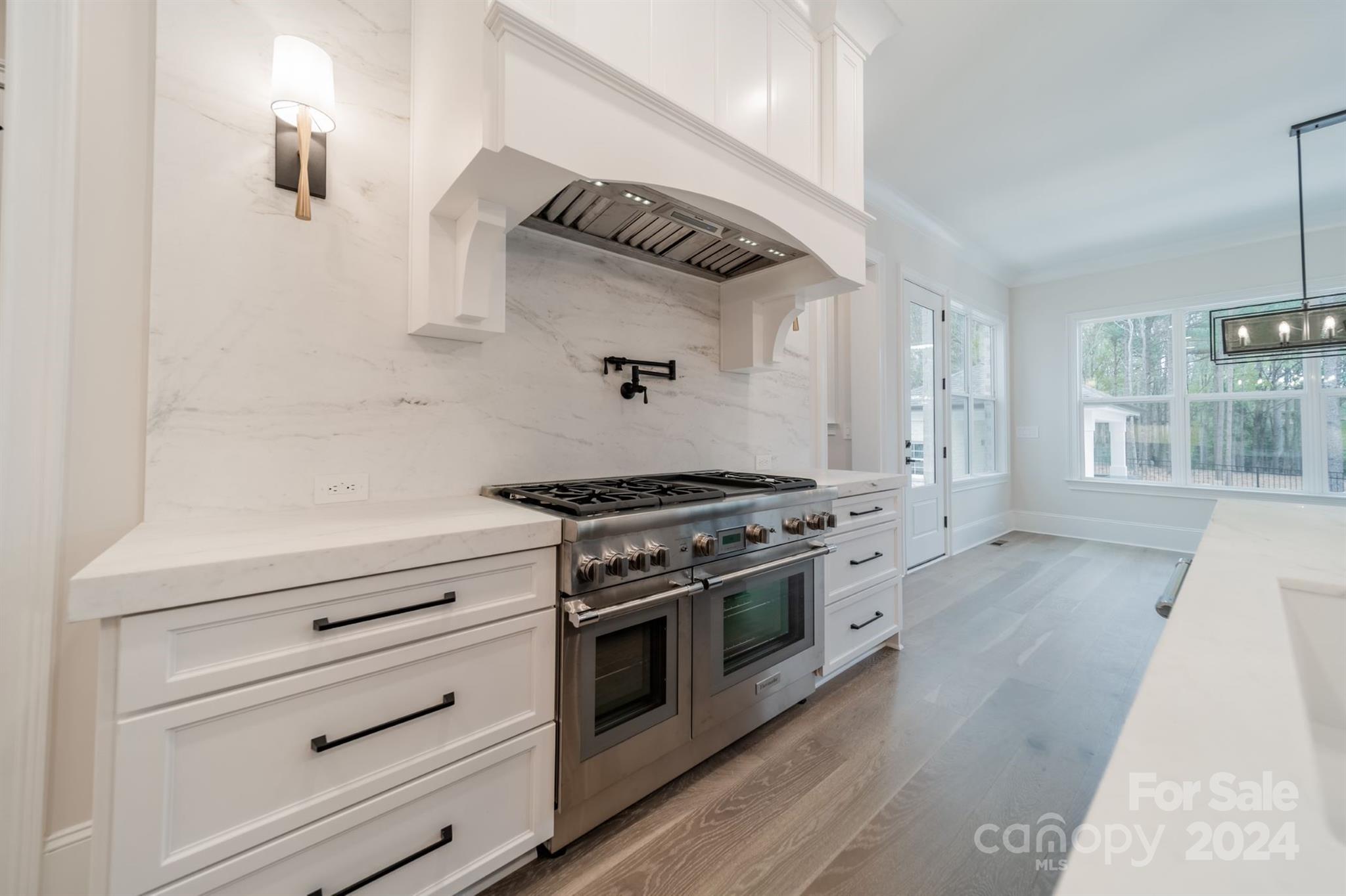 10829 Caroline Acres Road Fort Mill, SC 29707 - Photo 10 of 21 a kitchen with a stove and a wooden floor