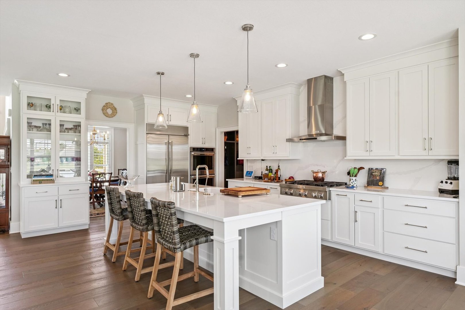 604 Cayman Way Savoy, IL 61874 - Photo 41 of 138 a kitchen with stainless steel appliances kitchen island granite countertop a stove a sink and white cabinets with wooden floor