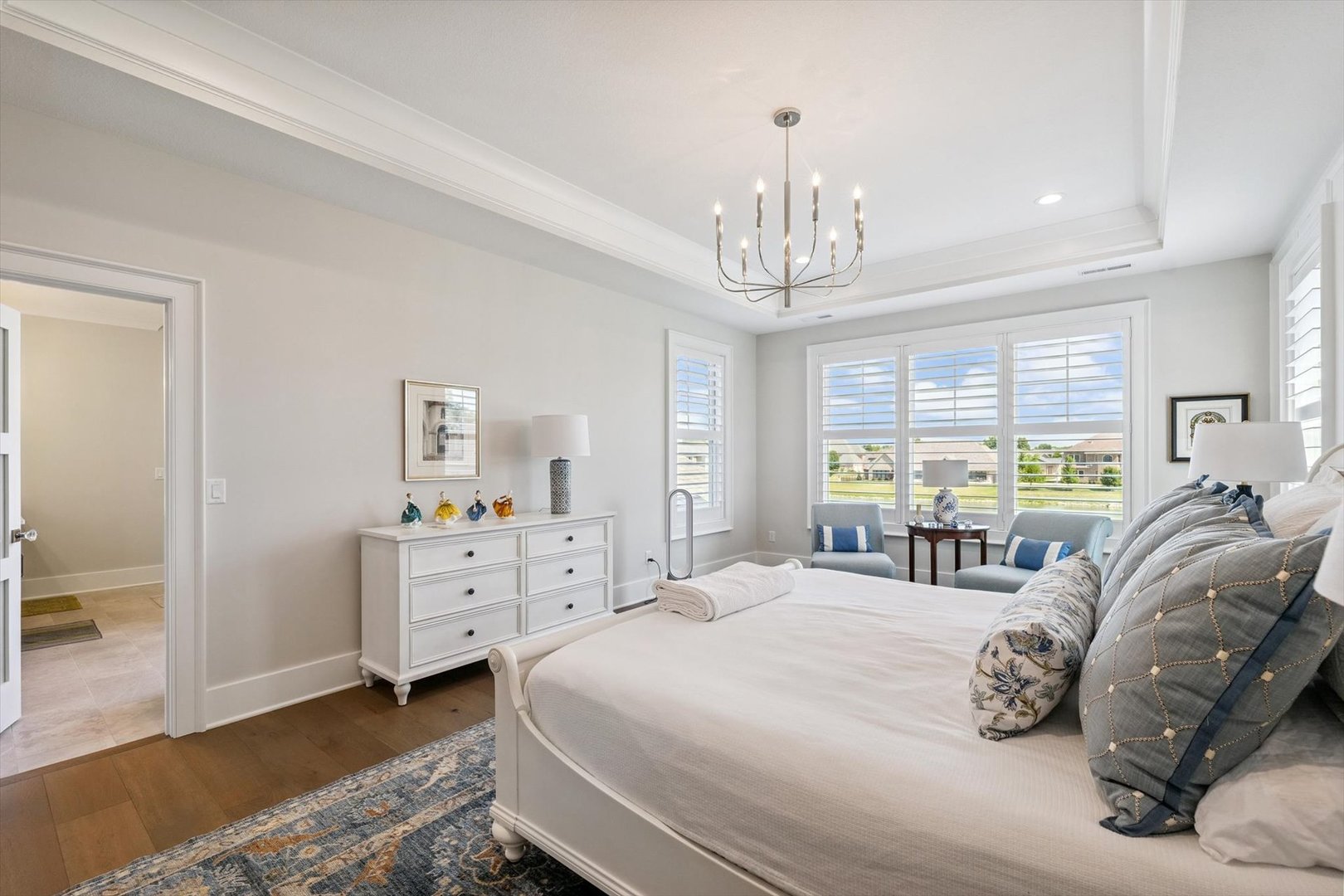 604 Cayman Way Savoy, IL 61874 - Photo 87 of 138 a bedroom with a bed and a chandelier