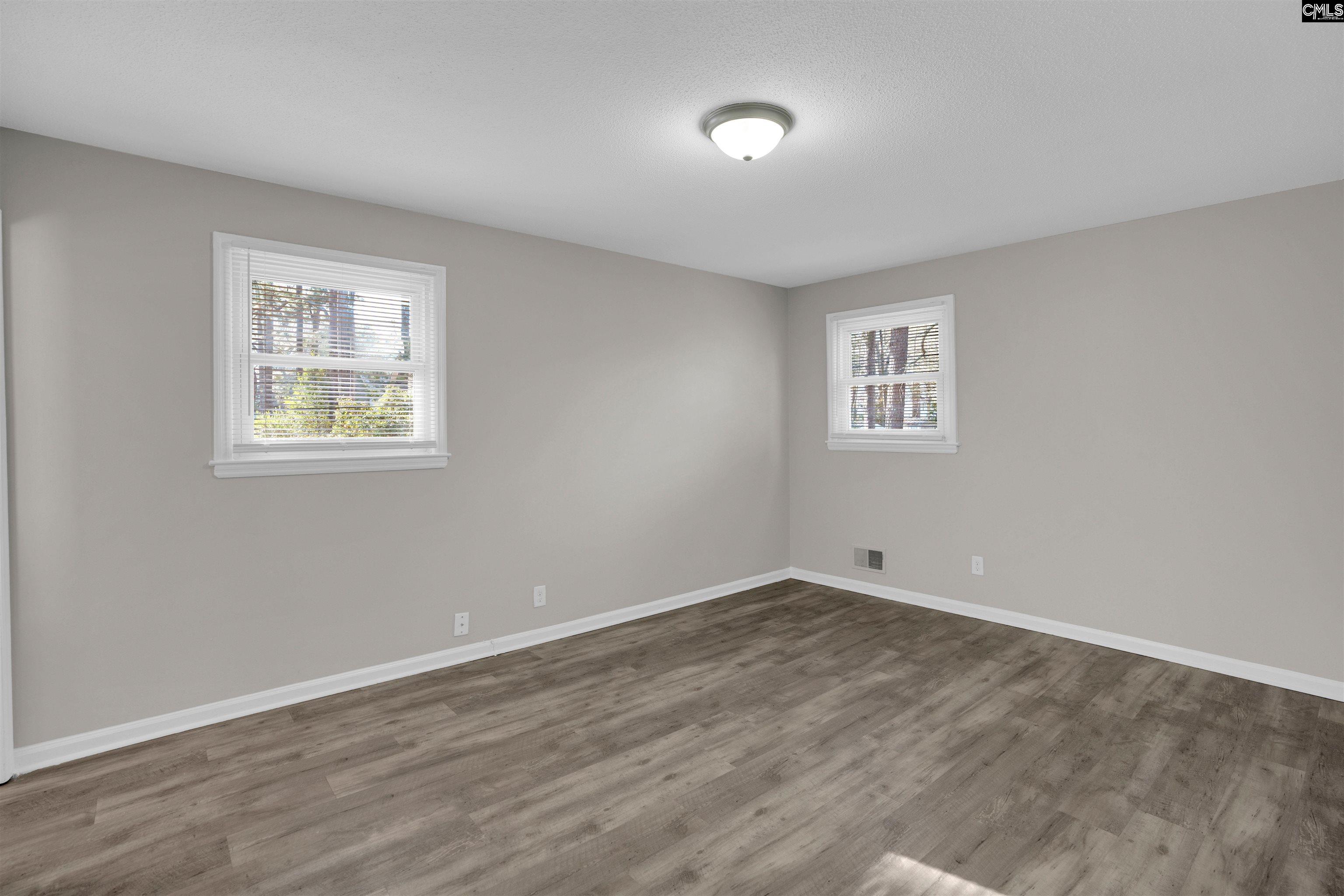 2620 Pleasant Ridge Drive Columbia, SC 29209 - Photo 23 of 37 a view of an empty room with a window and wooden floor
