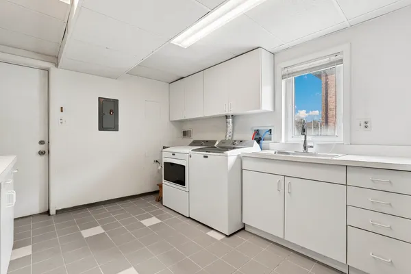 a kitchen with cabinets appliances and a sink