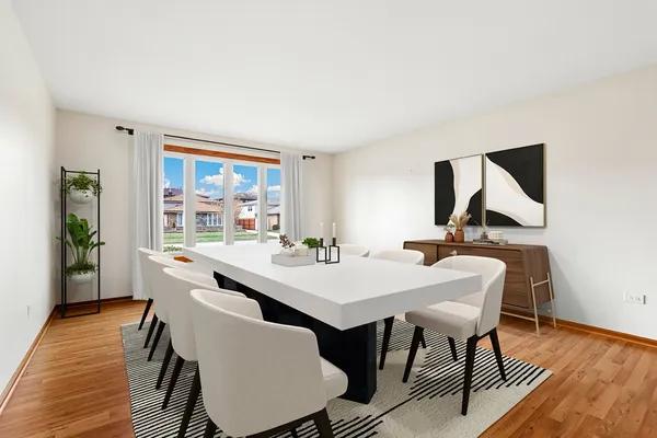 a view of a dining room with furniture wooden floor and window