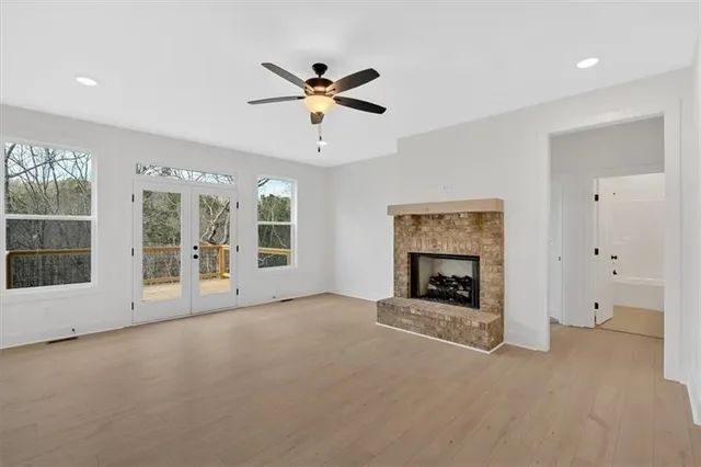 a view of an empty room with a fireplace and a window