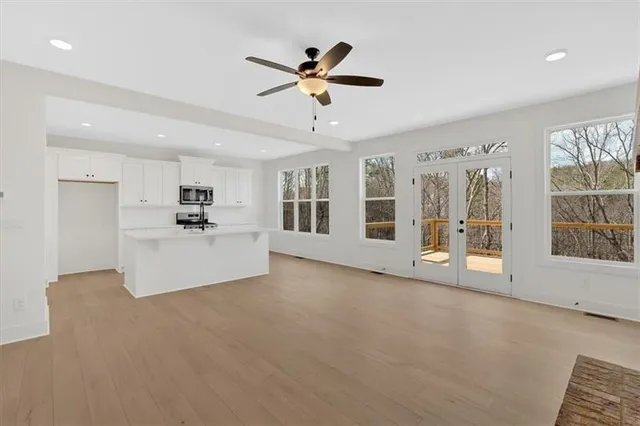 a view of an empty room with window and cabinet