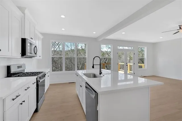 a kitchen with sink stove and cabinets