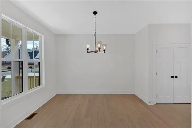 a view of a room with wooden floor and windows