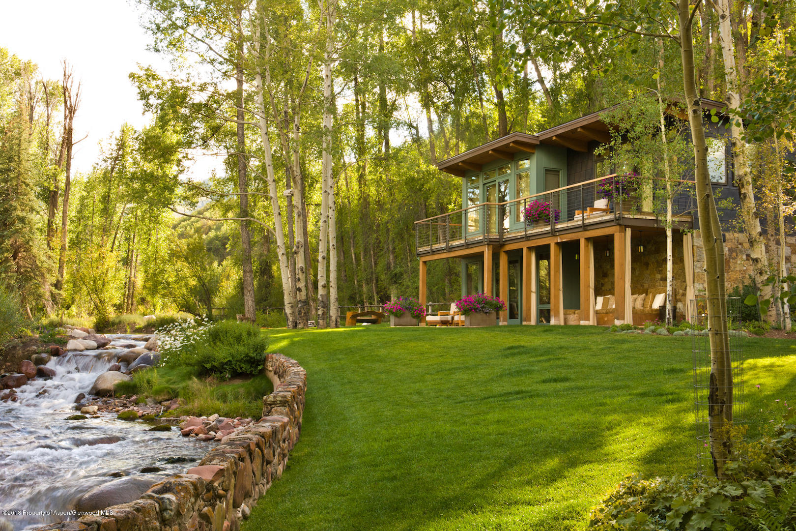 1055 Stage Road Aspen, CO 81611 - Photo 11 of 32 a view of a big building with a big yard and large trees
