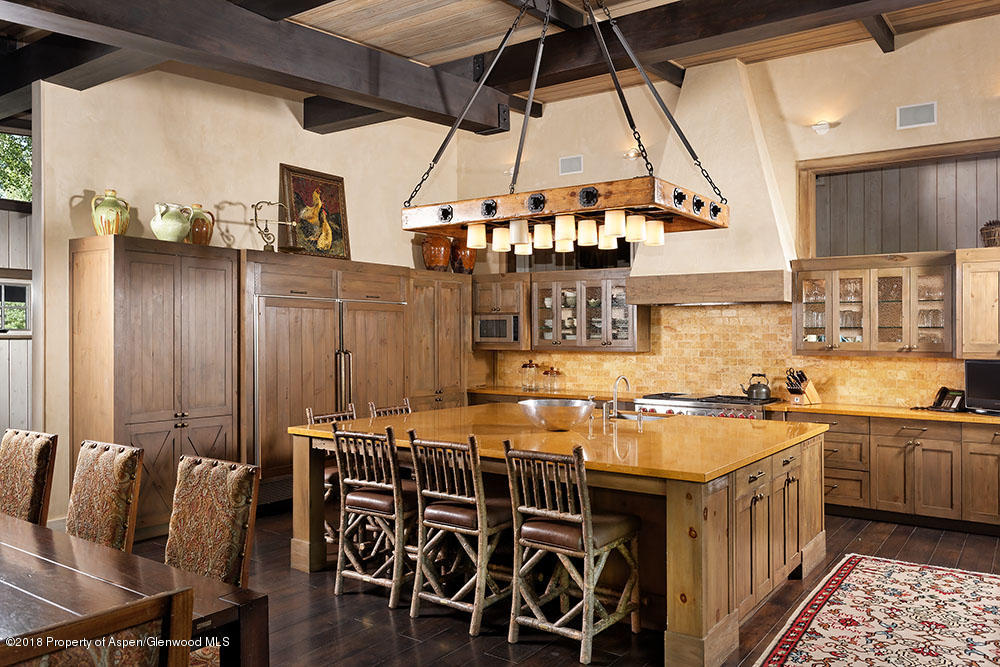 1055 Stage Road Aspen, CO 81611 - Photo 16 of 32 a kitchen with a table chairs stove and cabinets