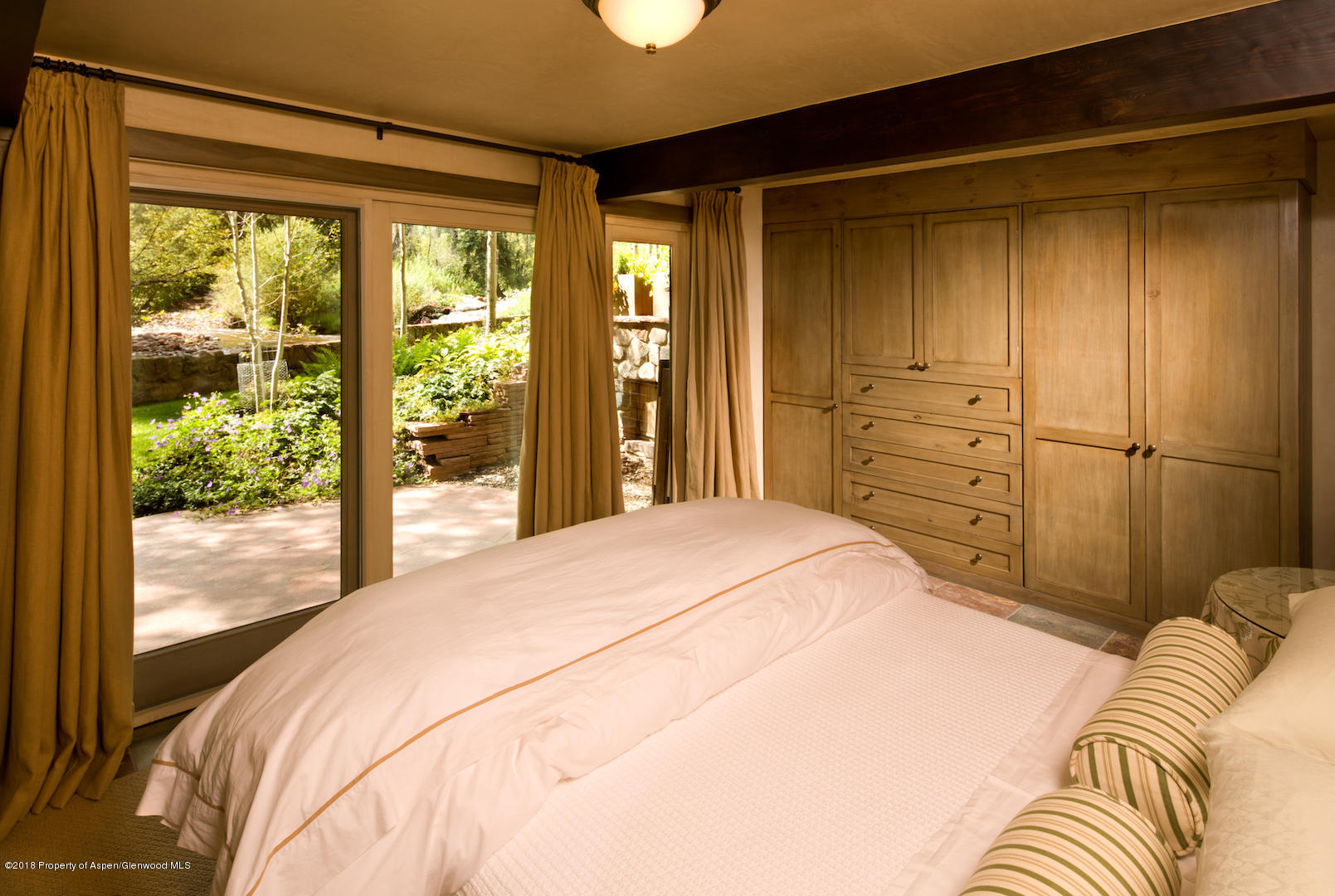 1055 Stage Road Aspen, CO 81611 - Photo 20 of 32 a bedroom with a bed and large window