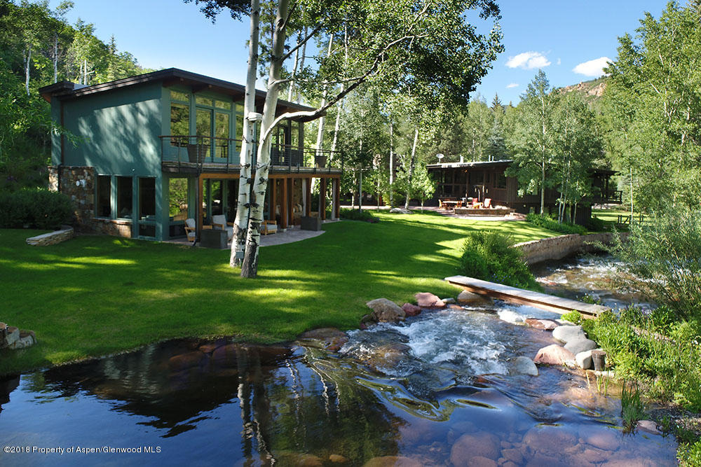 1055 Stage Road Aspen, CO 81611 - Photo 2 of 32 a view of a yard with plants and a fountain