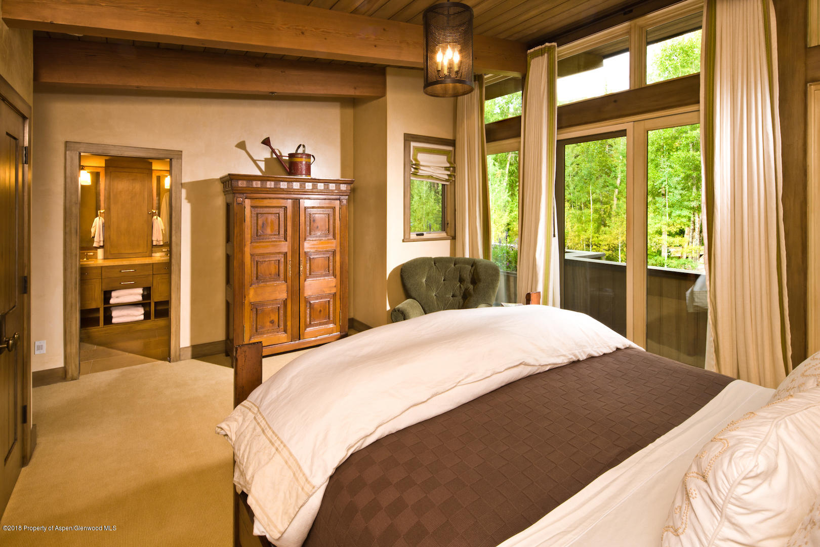 1055 Stage Road Aspen, CO 81611 - Photo 21 of 32 a bedroom with a large bed and a large window