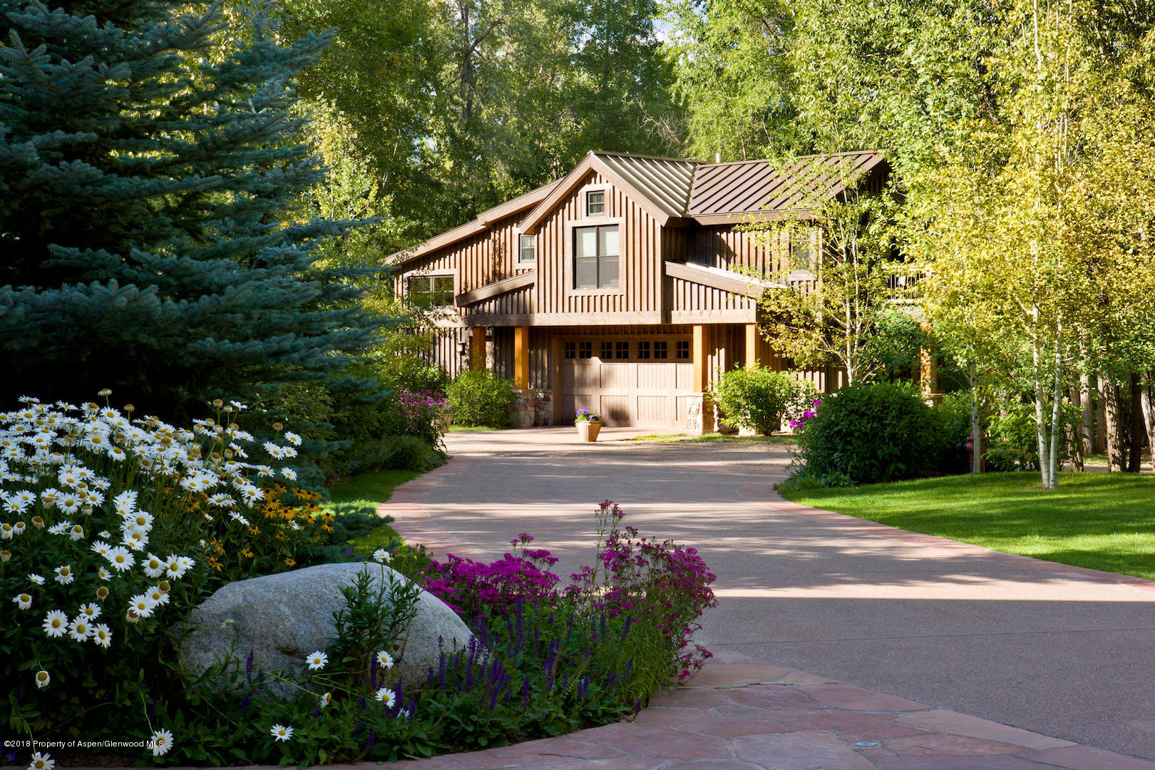 1055 Stage Road Aspen, CO 81611 - Photo 32 of 32 a front view of a house with a yard and garage