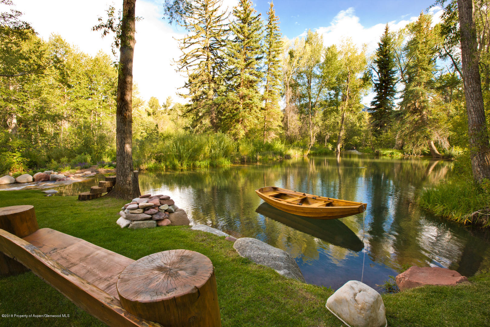 1055 Stage Road Aspen, CO 81611 - Photo 8 of 32 a view of a backyard with table and chairs and fire pit