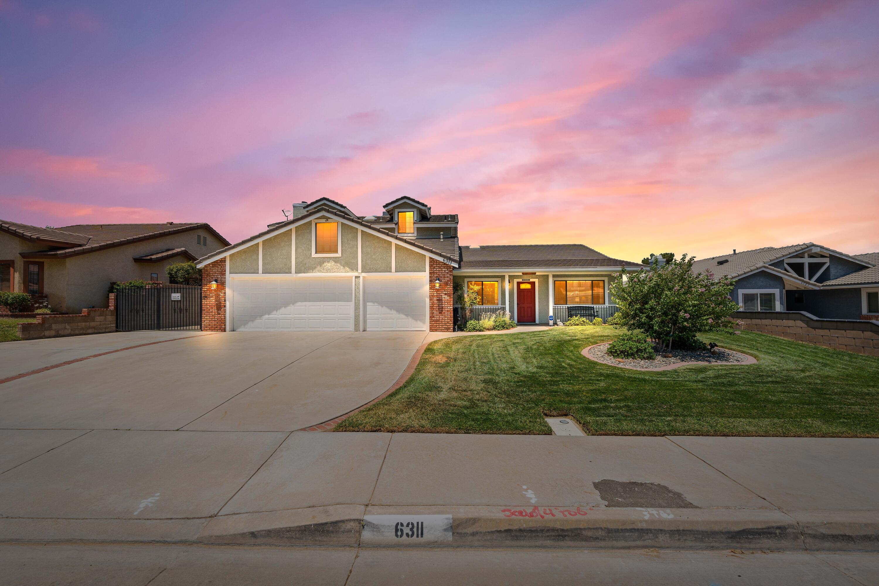 a view of house with yard and green space