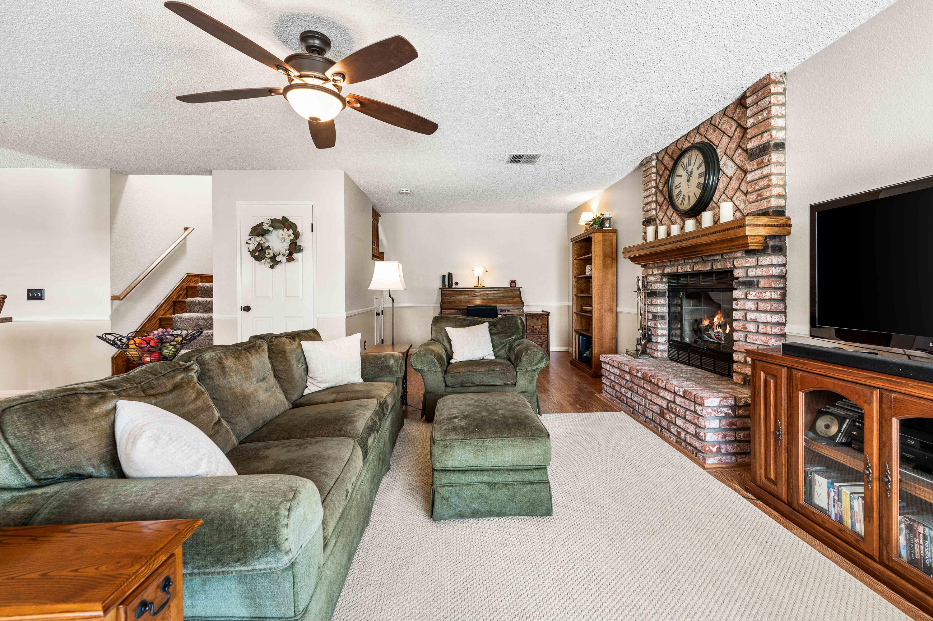 6311 West Ave L12 Lancaster, CA 93536 - Photo 17 of 55 a living room with fireplace furniture and a flat screen tv