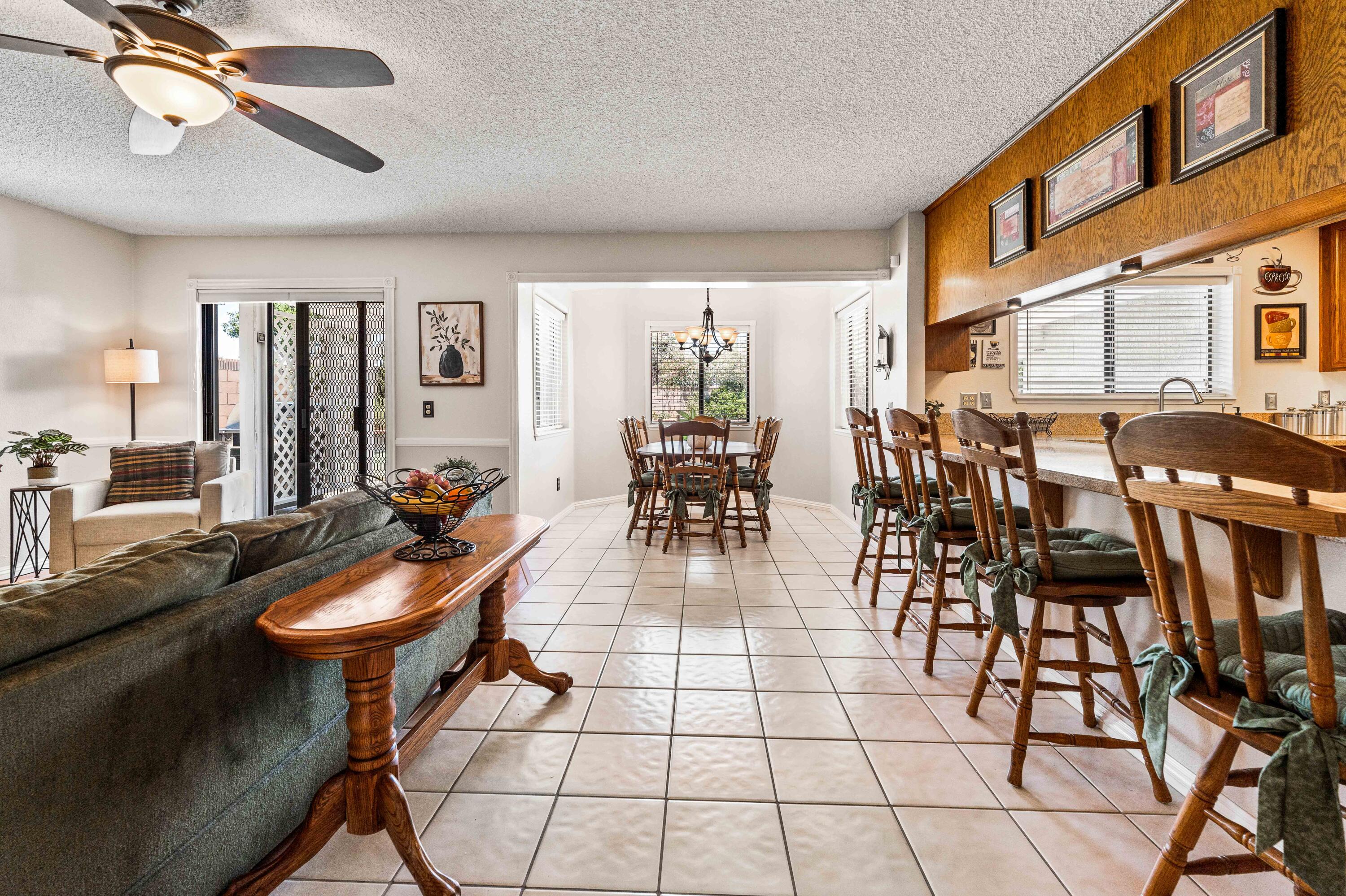 6311 West Ave L12 Lancaster, CA 93536 - Photo 19 of 55 a dining hall with couches a dining table and chairs with wooden floor