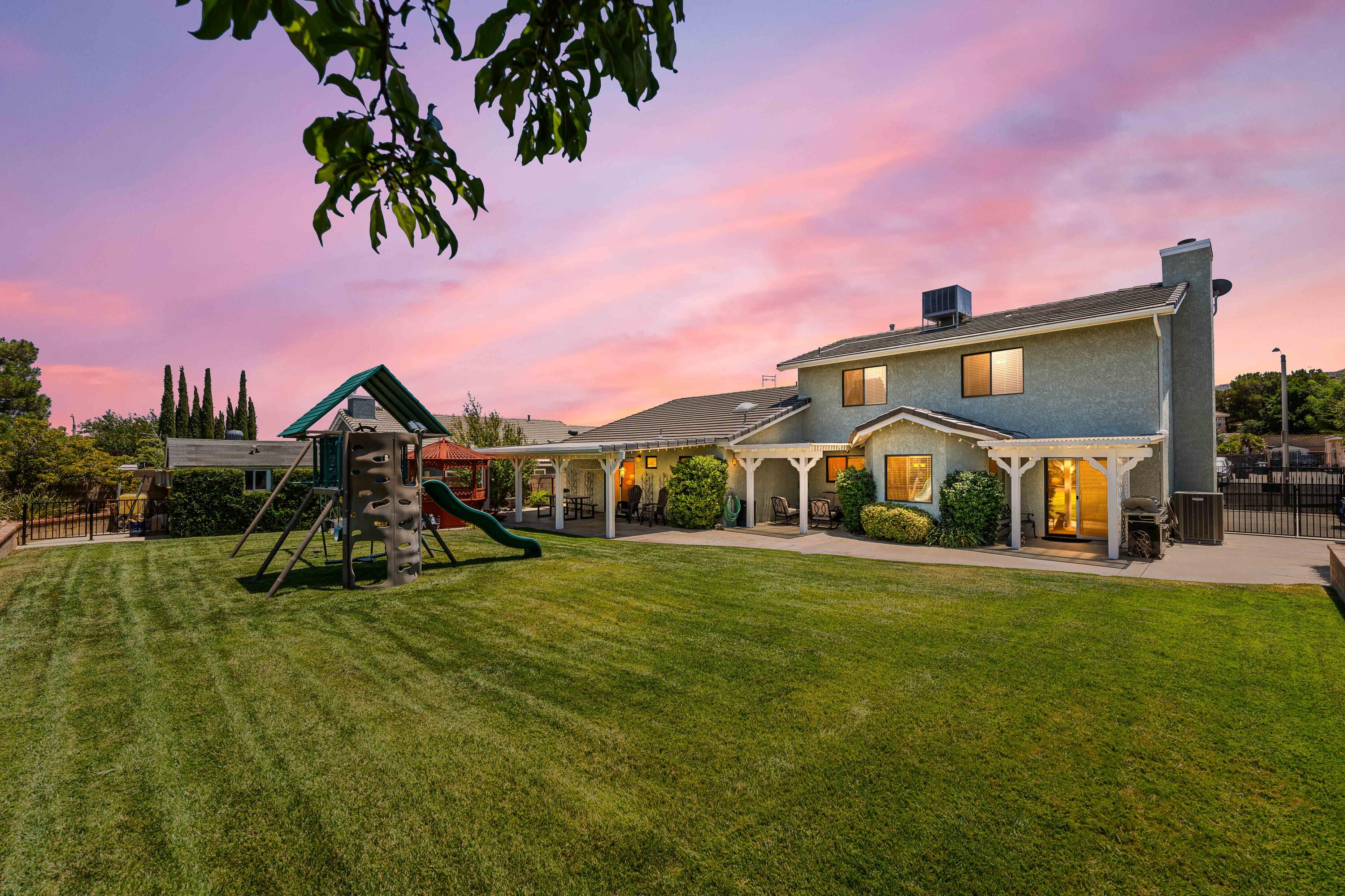 6311 West Ave L12 Lancaster, CA 93536 - Photo 2 of 55 a front view of a house with a yard and garage