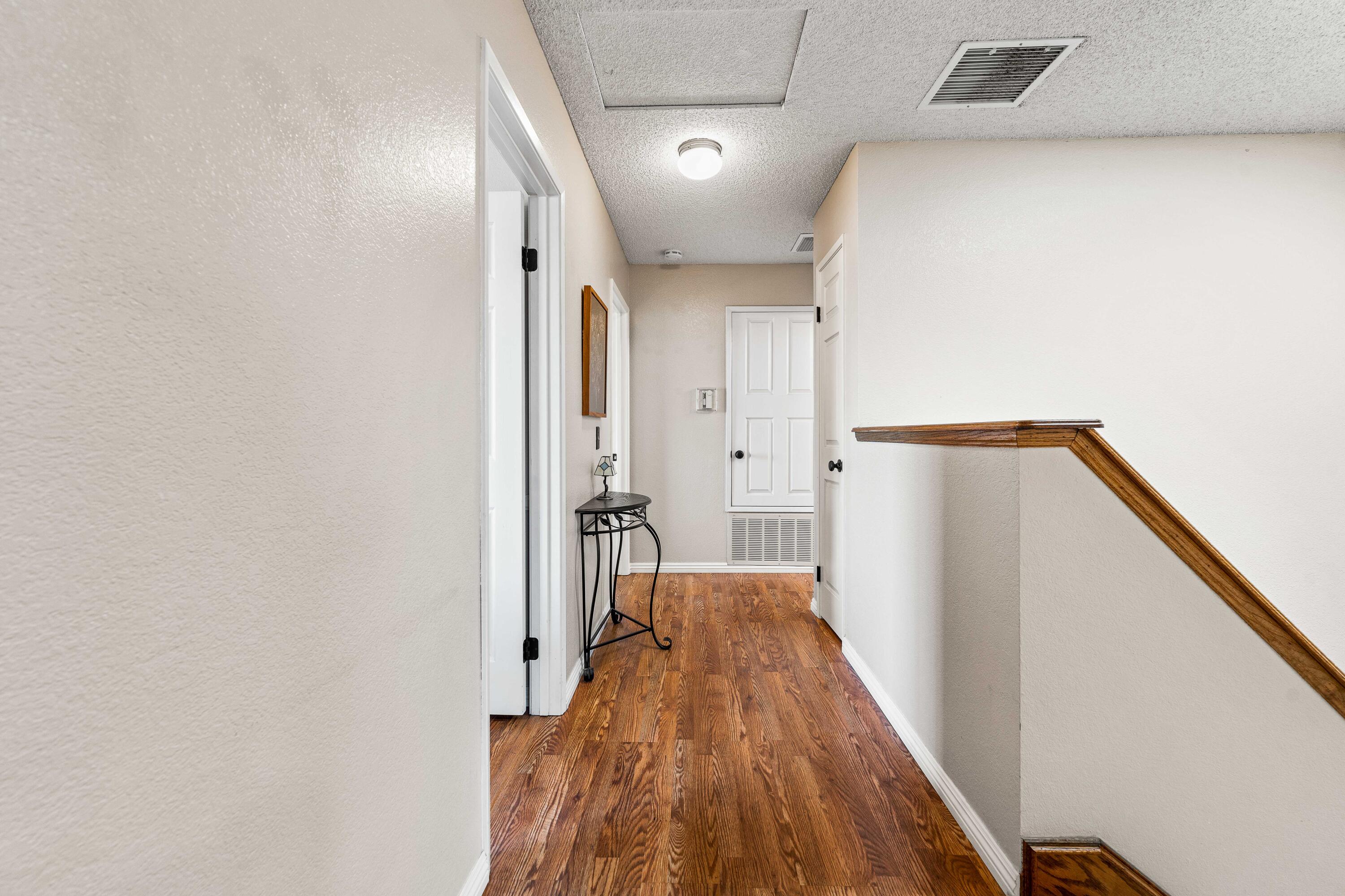6311 West Ave L12 Lancaster, CA 93536 - Photo 21 of 55 a view of a hallway with wooden floor and staircase