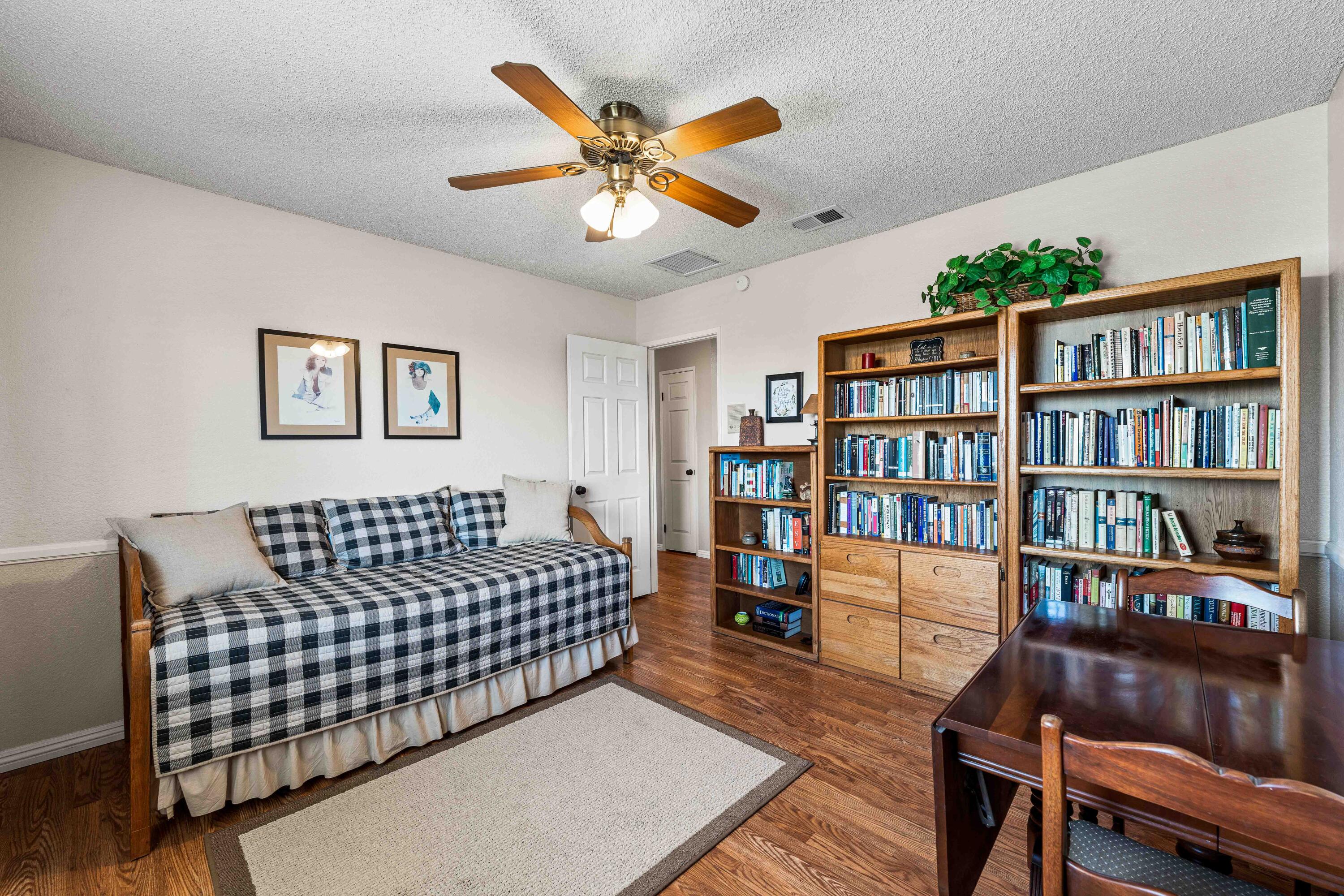 6311 West Ave L12 Lancaster, CA 93536 - Photo 25 of 55 a living room with furniture rug and a book shelf