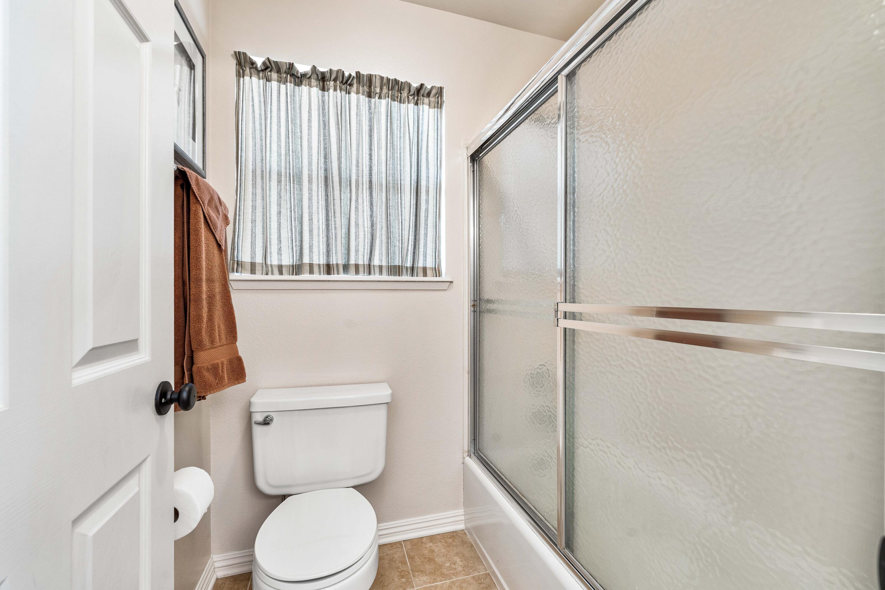 6311 West Ave L12 Lancaster, CA 93536 - Photo 30 of 55 a white toilet sitting next to a shower