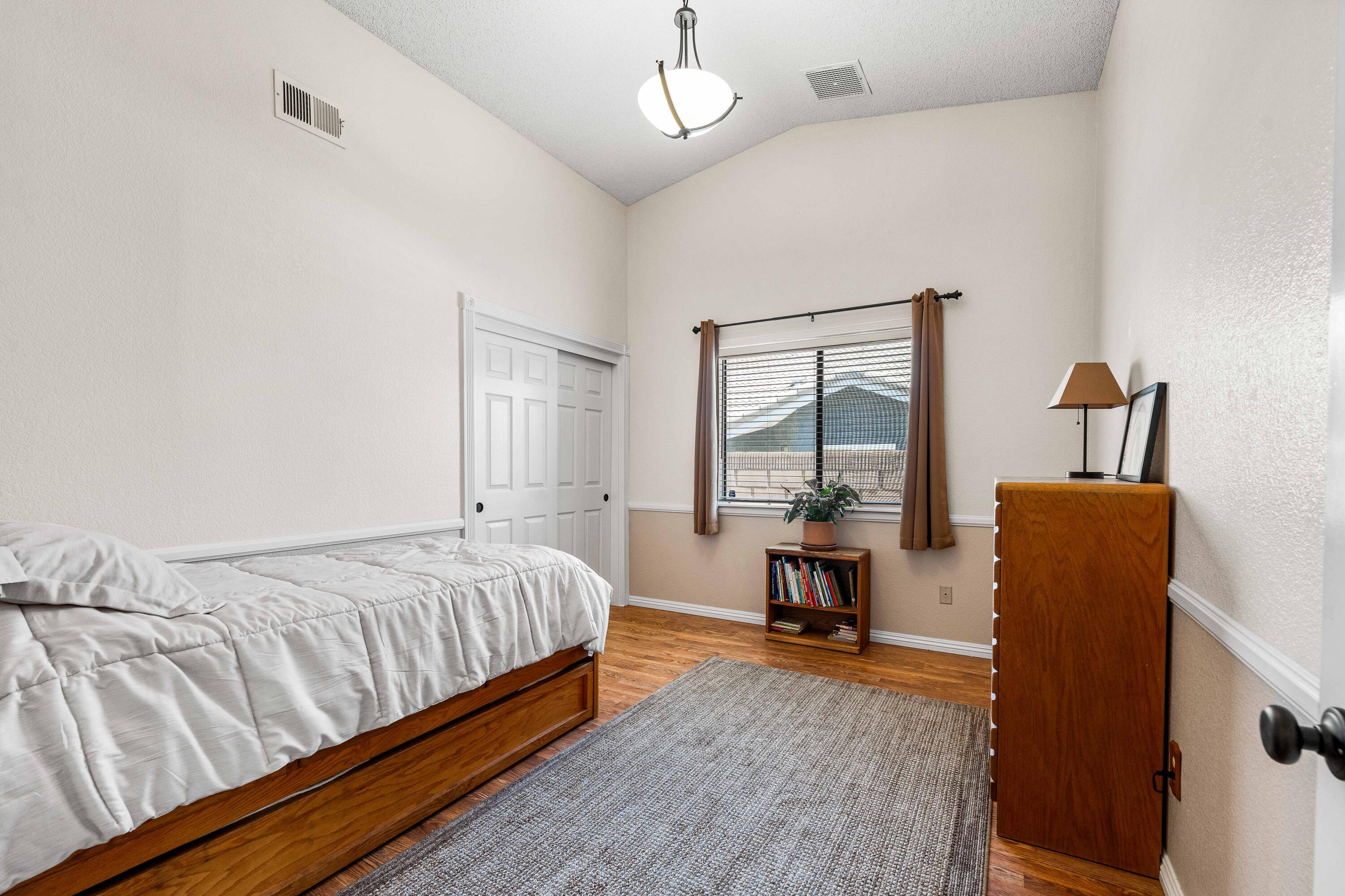 6311 West Ave L12 Lancaster, CA 93536 - Photo 32 of 55 a bedroom with a bed and wooden floor