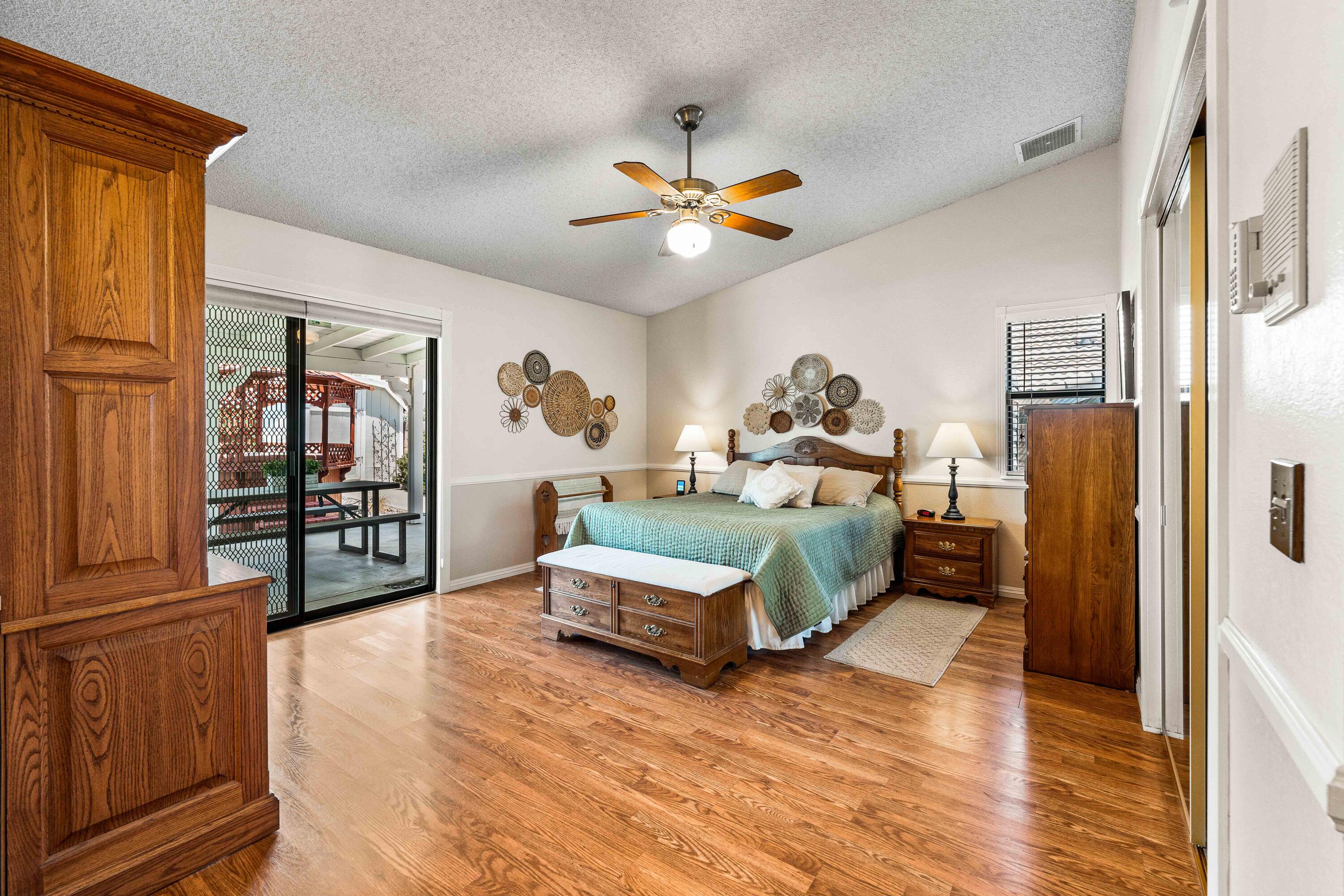 6311 West Ave L12 Lancaster, CA 93536 - Photo 36 of 55 a bedroom with furniture and a wooden floor