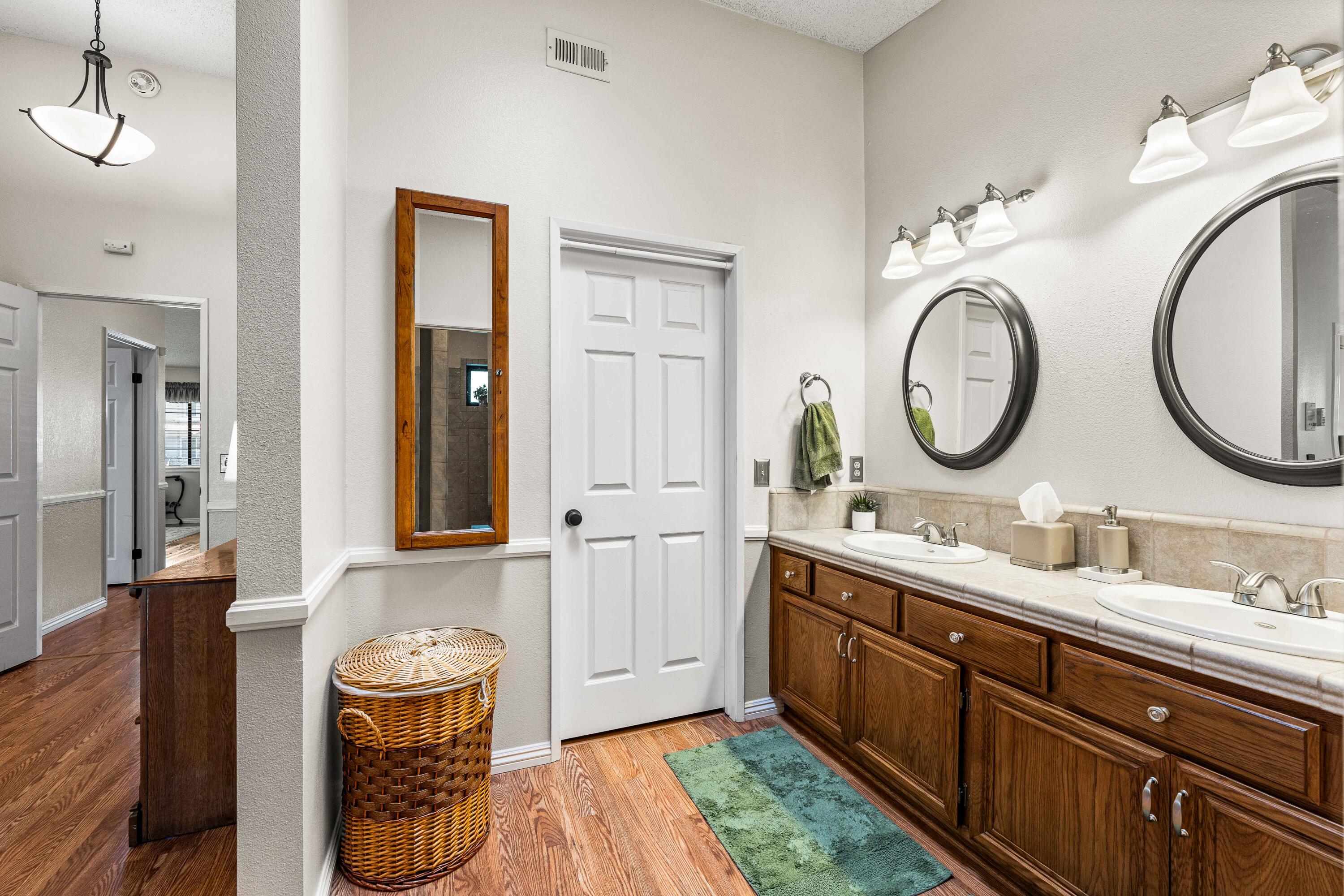 6311 West Ave L12 Lancaster, CA 93536 - Photo 39 of 55 a bathroom with a double vanity sink and a mirror