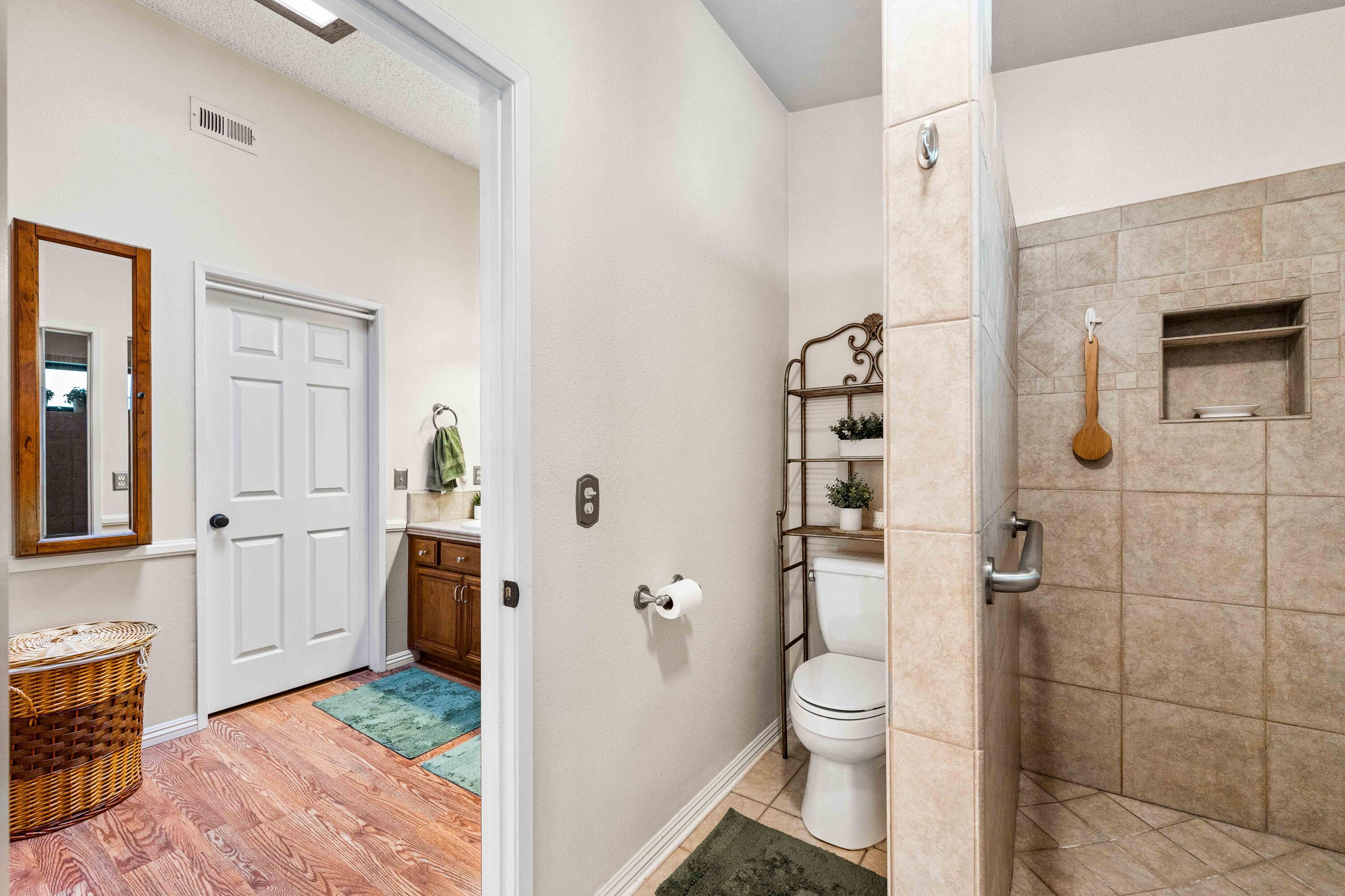 6311 West Ave L12 Lancaster, CA 93536 - Photo 41 of 55 a bathroom with a toilet a sink and shower