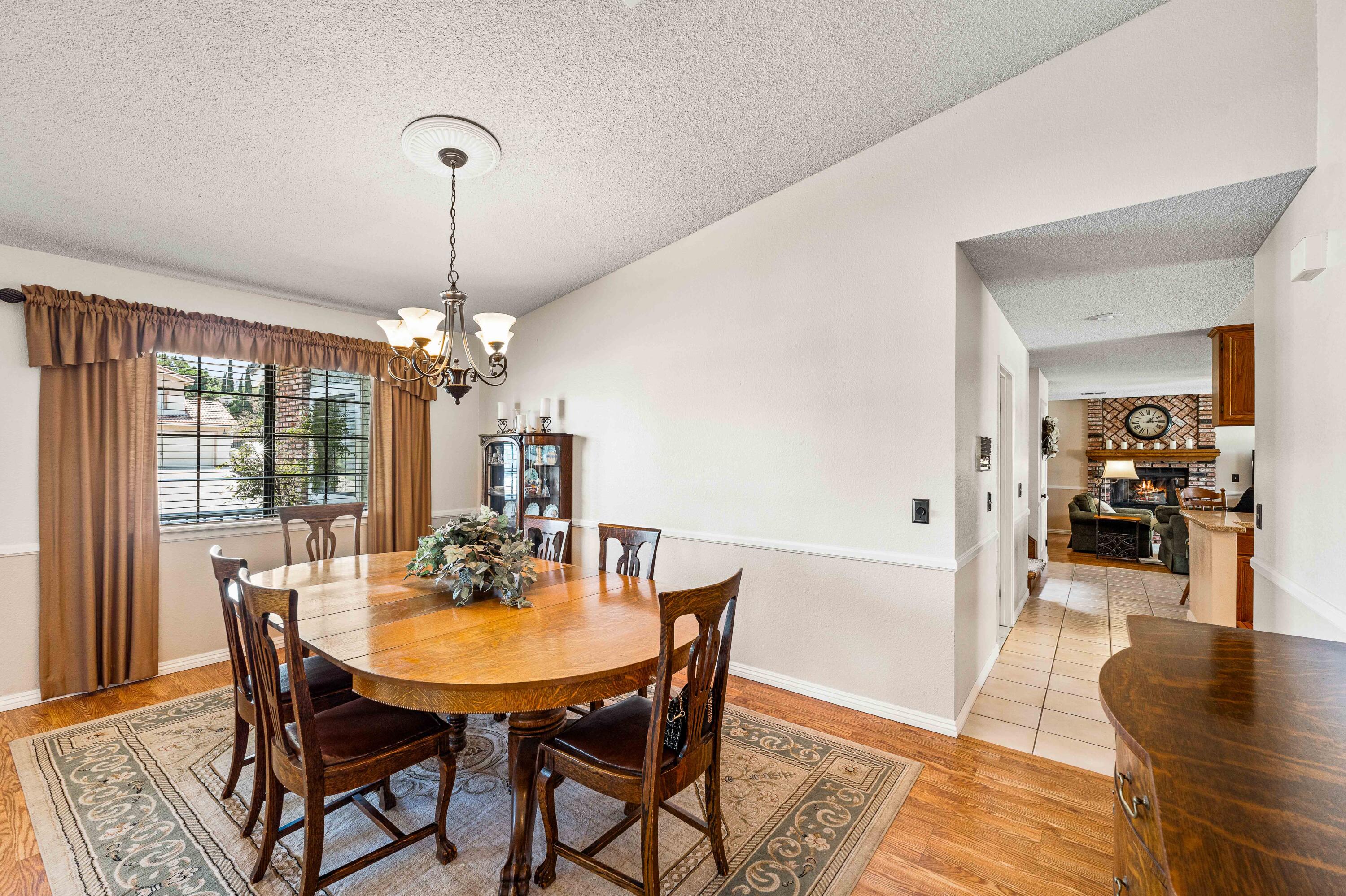 6311 West Ave L12 Lancaster, CA 93536 - Photo 10 of 55 a view of a dining room with furniture window and wooden floor