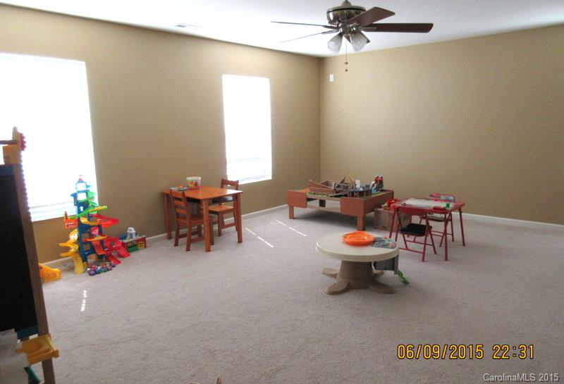 1135 Spicewood Pines Road, Unit 15 Fort Mill, SC 29708 - Photo 13 of 15 a room with furniture and chandelier