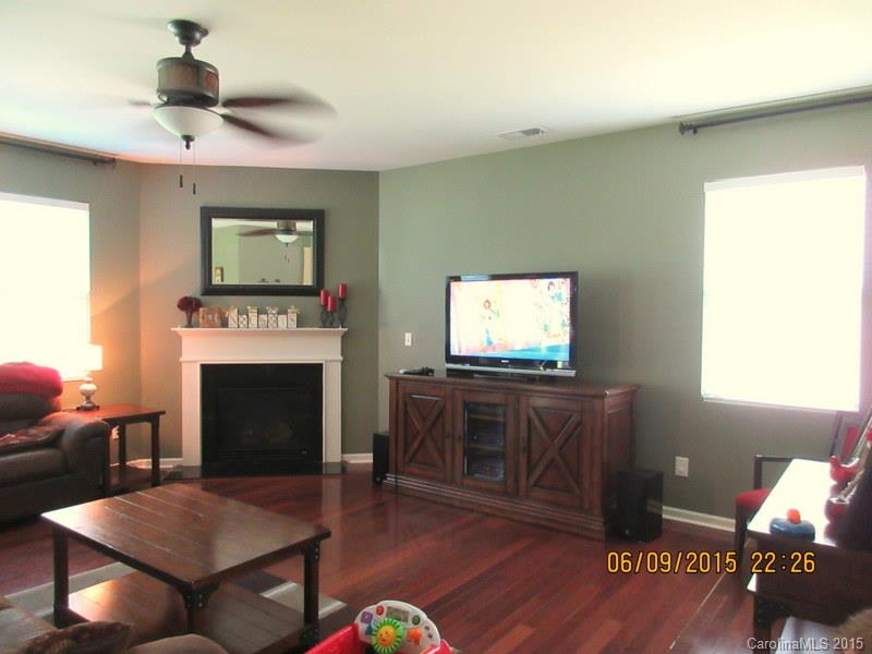 1135 Spicewood Pines Road, Unit 15 Fort Mill, SC 29708 - Photo 5 of 15 a living room with furniture a flat screen tv and a fireplace
