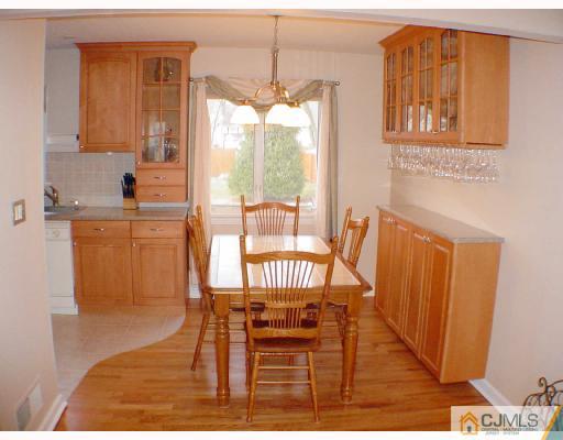 13 Leland Road Edison, NJ 08817 - Photo 3 of 10 a view of a dining room with furniture a chandelier and wooden floor