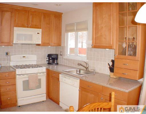 13 Leland Road Edison, NJ 08817 - Photo 4 of 10 a kitchen with stainless steel appliances granite countertop a sink stove and cabinets