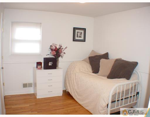 13 Leland Road Edison, NJ 08817 - Photo 7 of 10 a bedroom with a bed and a window