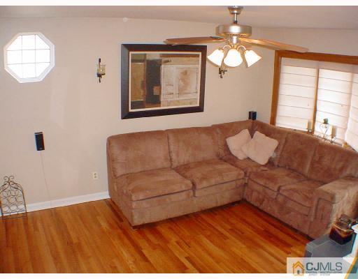 13 Leland Road Edison, NJ 08817 - Photo 8 of 10 a living room with furniture and a large mirror