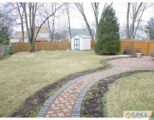 13 Leland Road Edison, NJ 08817 - Photo 9 of 10 a house with trees in front of it