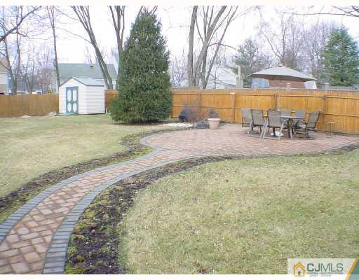 13 Leland Road Edison, NJ 08817 - Photo 10 of 10 a view of pool with outdoor seating and covered with trees
