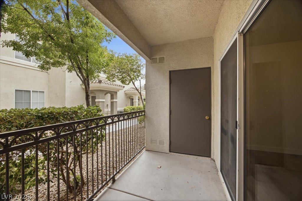 9050 West Warm Springs Road, Unit 1033 Las Vegas, NV 89148 - Photo 16 of 26 A private patio space, perfect for tranquil outdoor moments, overlooks verdant landscaping and surrounding architecture.