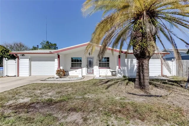 a view of a house with backyard and porch