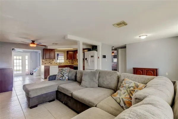 a view of living room kitchen with furniture and wooden floor