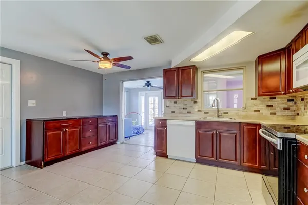 a kitchen with stainless steel appliances granite countertop a sink dishwasher stove and cabinets