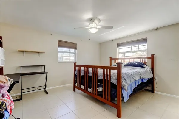 a bed sitting in a bedroom next to a window